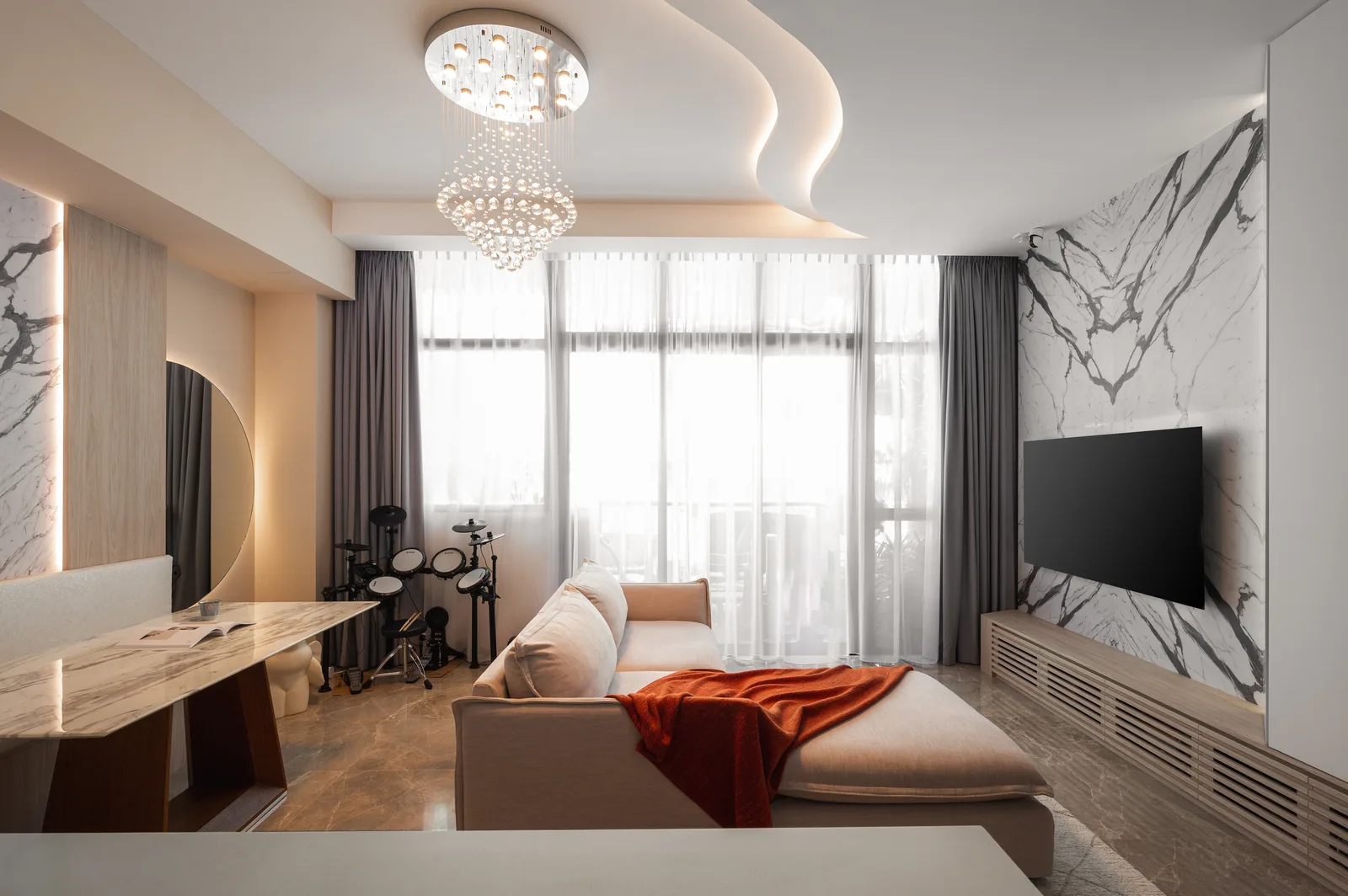A warm living room with a bookmatched marble feature wall and walnut joinery